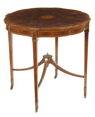 Appraisal: An Edwardian mahogany centre table the shaped circular top with