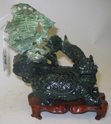 Appraisal: A CHINESE CARVED JADE FIGURE apple green shading to spinach