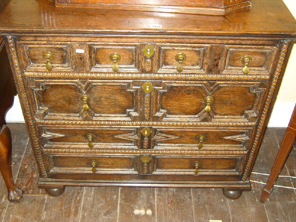 Appraisal: A Jacobean chest fitted with an arrangement of four long