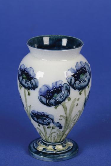 Appraisal: A TH CENTURY MOORCROFT MACINTYRE FLORIAN WARE MINIATURE VASE decorated