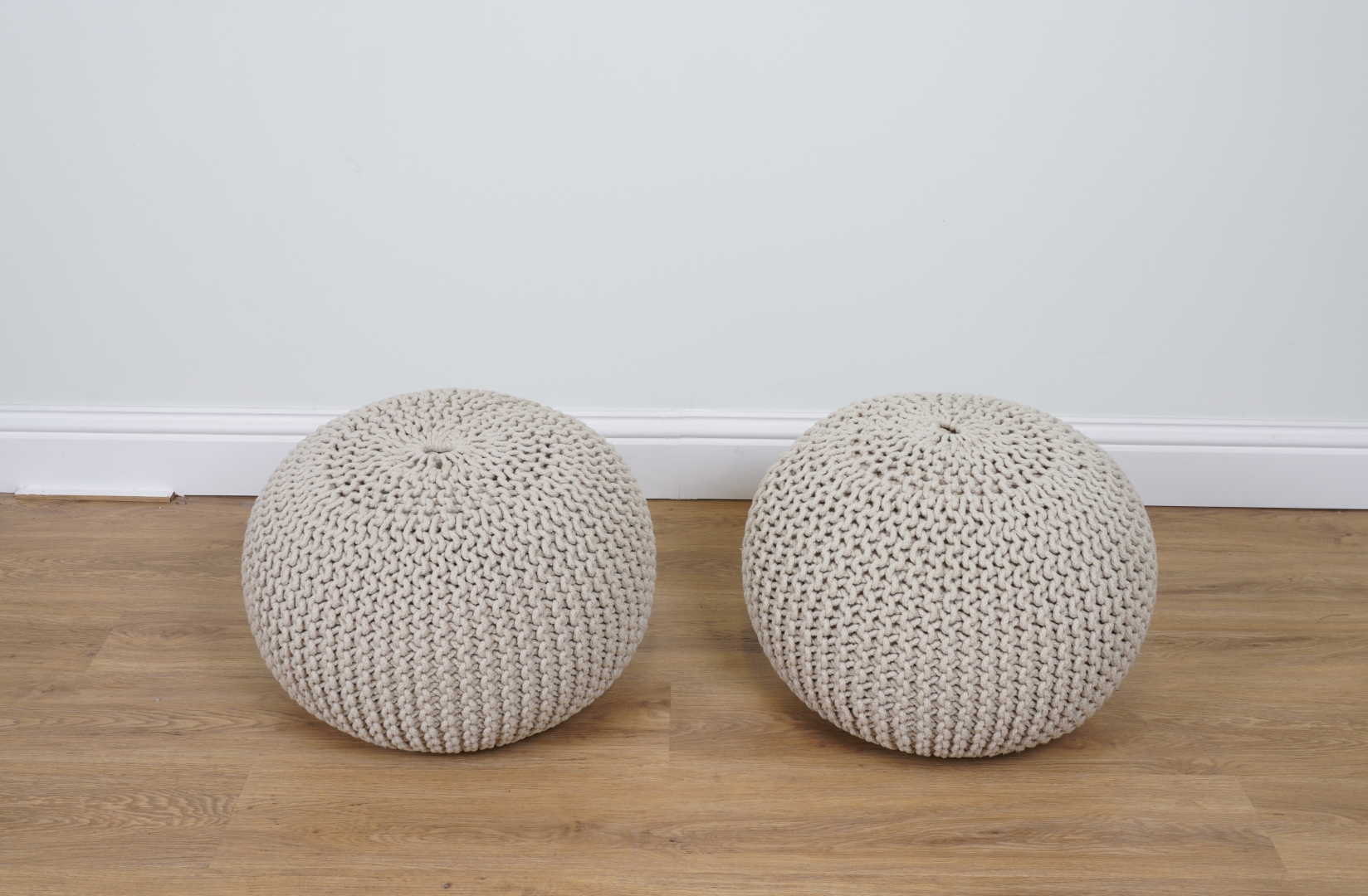 Appraisal: A PAIR OF COTTON UPHOLSTERED POUFFES cm high