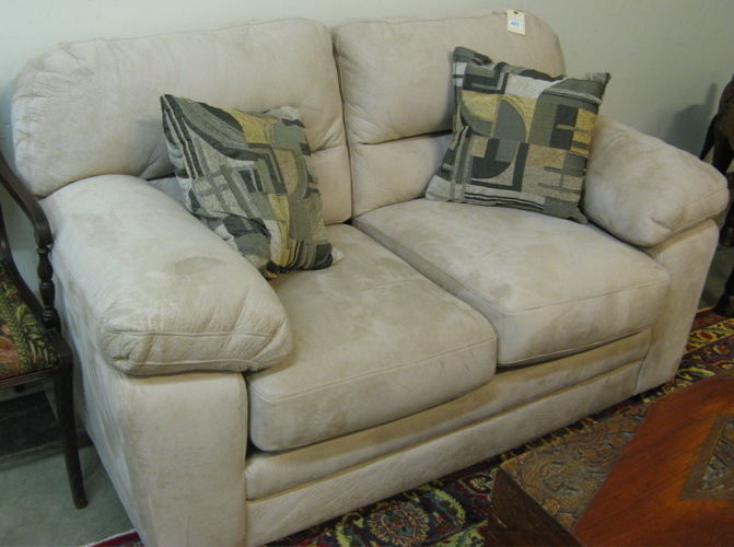 Appraisal: CONTEMPORARY LOVESEAT with overall plain beige fabric upholstery and a