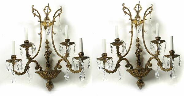 Appraisal: A pair of gilt metal and crystal four light wall