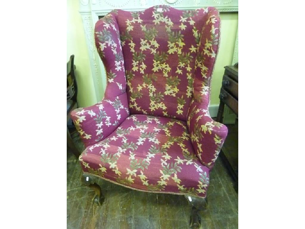 Appraisal: A Georgian style wing armchair with shaped outline and floral