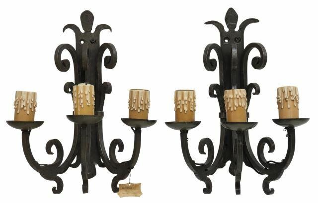 Appraisal: pair French Gothic style wrought iron three-light wall sconces M