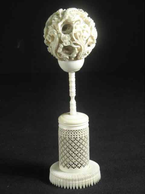 Appraisal: An intricately carved Chinese ivory mystery ball on stand Dragon