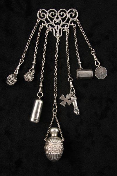 Appraisal: English Sterling Chatelaine with Charms scrolled open work pin with