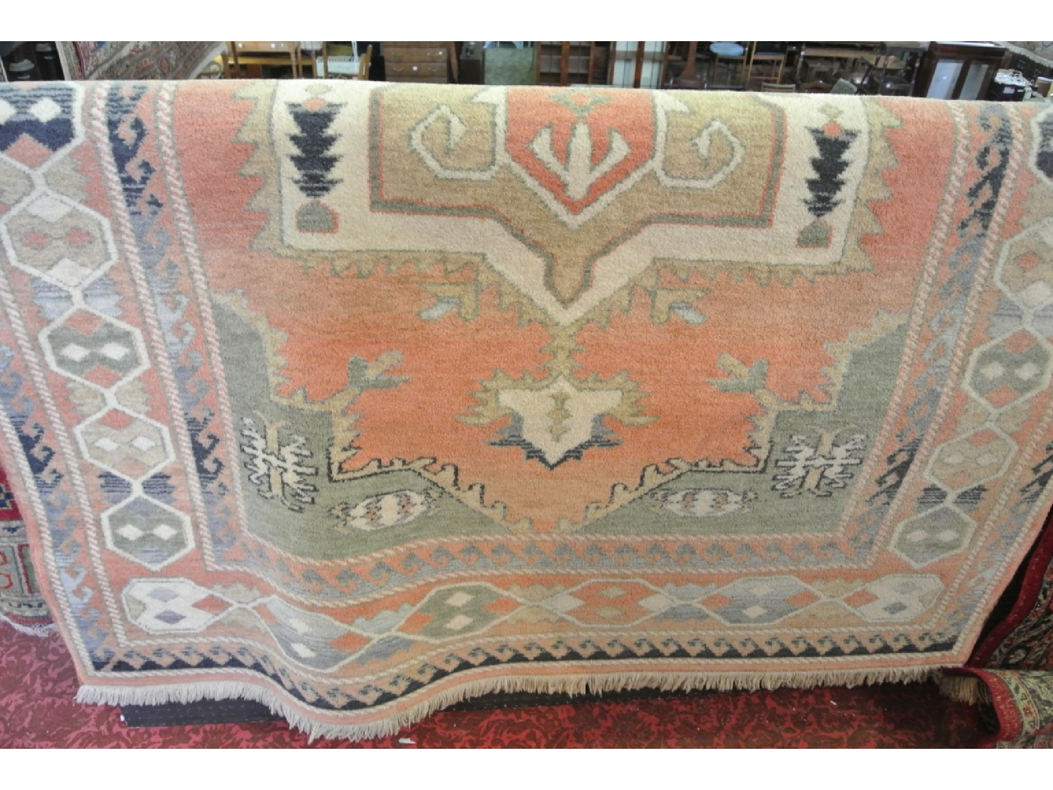 Appraisal: An Eastern style wool rug in pastel shades with geometric