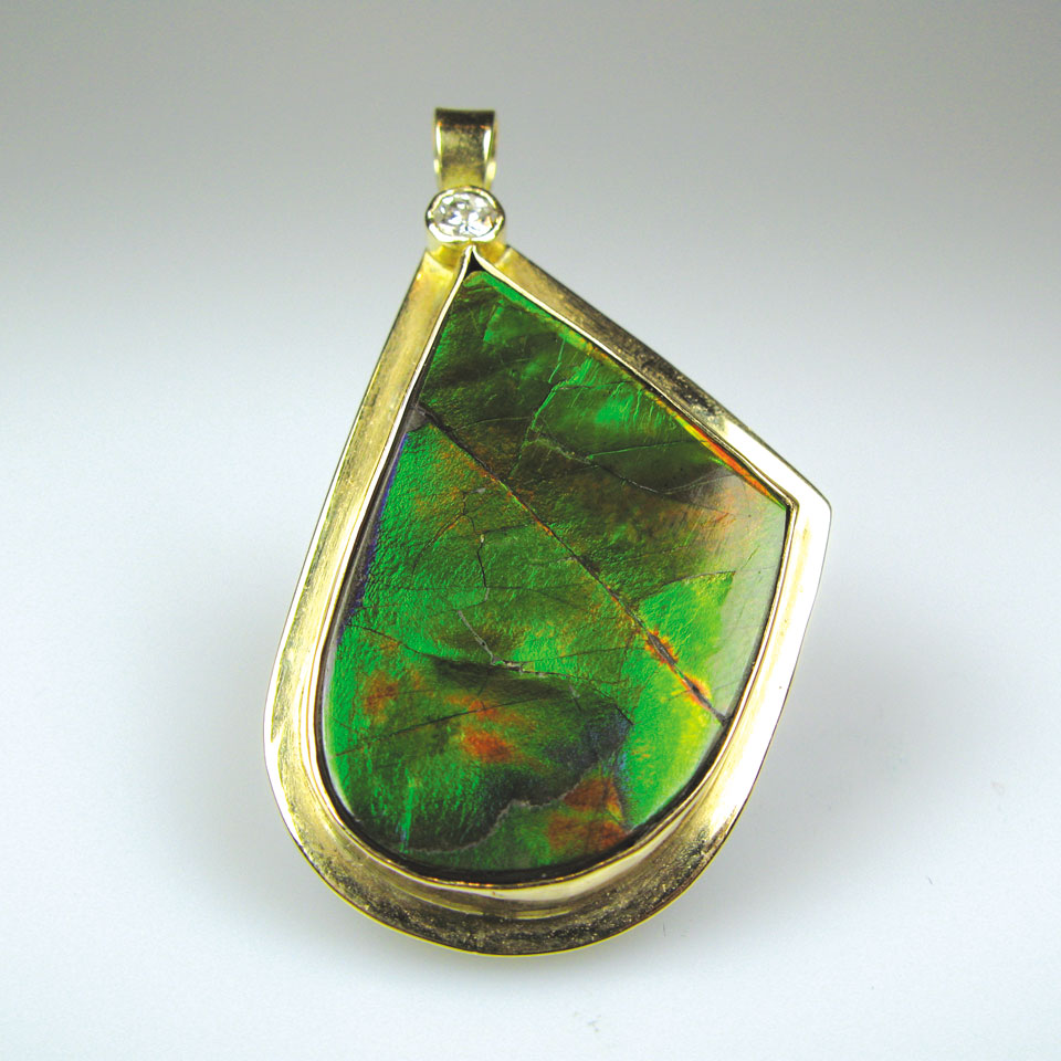 Appraisal: k yellow gold pendant set with a large freeform ammolite