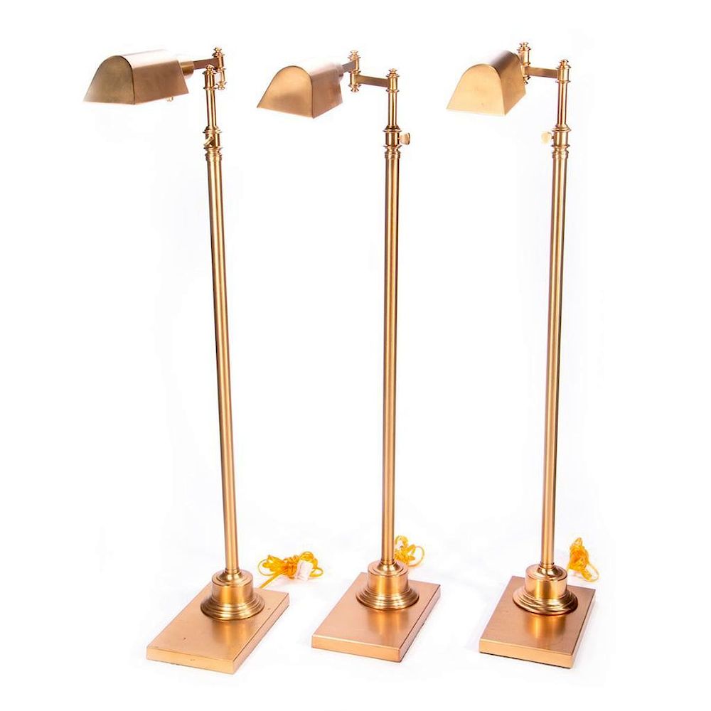 Appraisal: Three brass floor lamps Three contemporary brass floor lamps inches