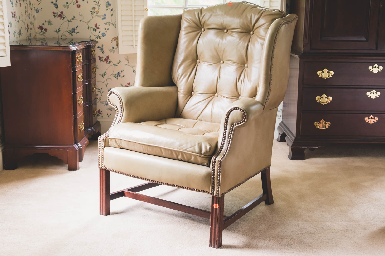 Appraisal: Chippendale style leather upholstered wing chair by Classic Leather in