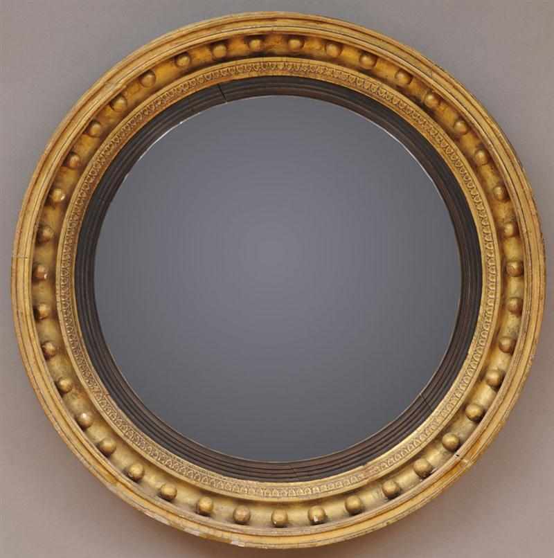 Appraisal: REGENCY CARVED GILTWOOD CONVEX MIRROR The plate within ebonized reeded