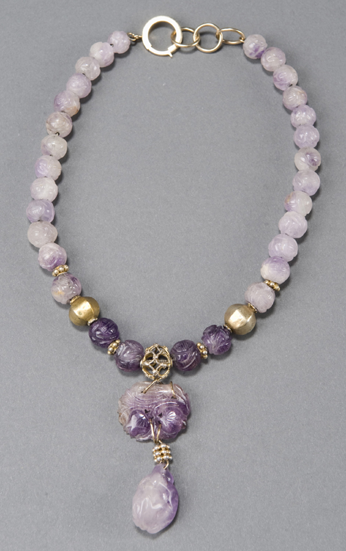 Appraisal: Marbled lavender jade necklace Beads are carved