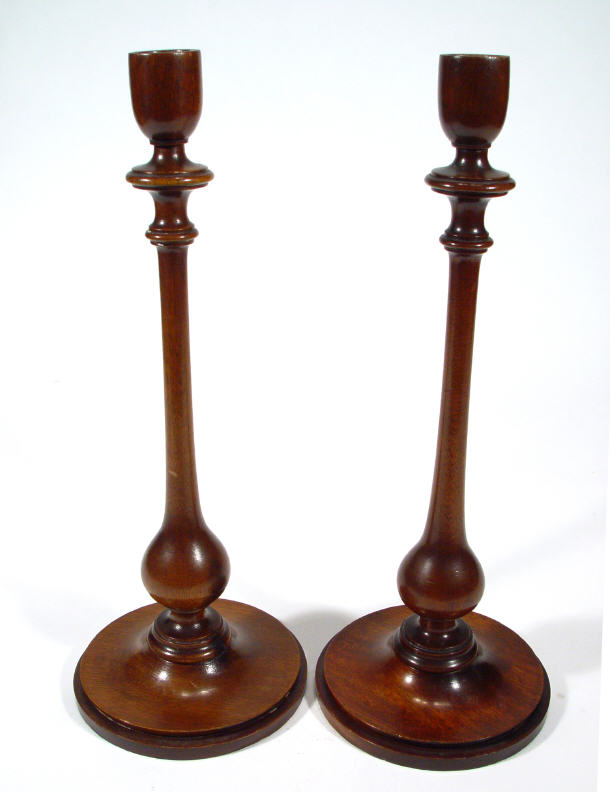 Appraisal: Pair of circular based mahogany candlesticks cm high