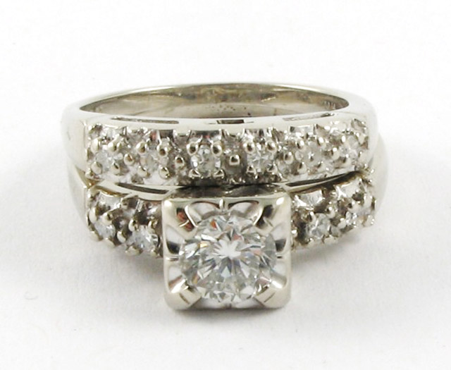 Appraisal: DIAMOND AND WHITE GOLD WEDDING SET The engagement ring centers