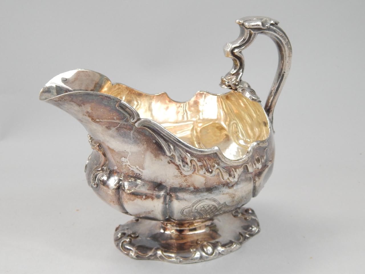 Appraisal: A white metal sauce boat in thC style decorated in