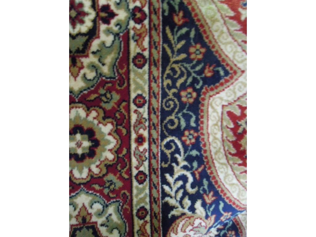 Appraisal: A large Indian style carpet with a central shaped medallion