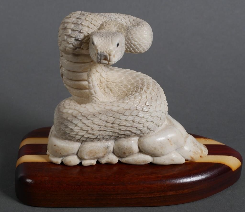 Appraisal: CARVED BONE RATTLESNAKE SCULPTURESuperbly handcarved bone statue of a rattler