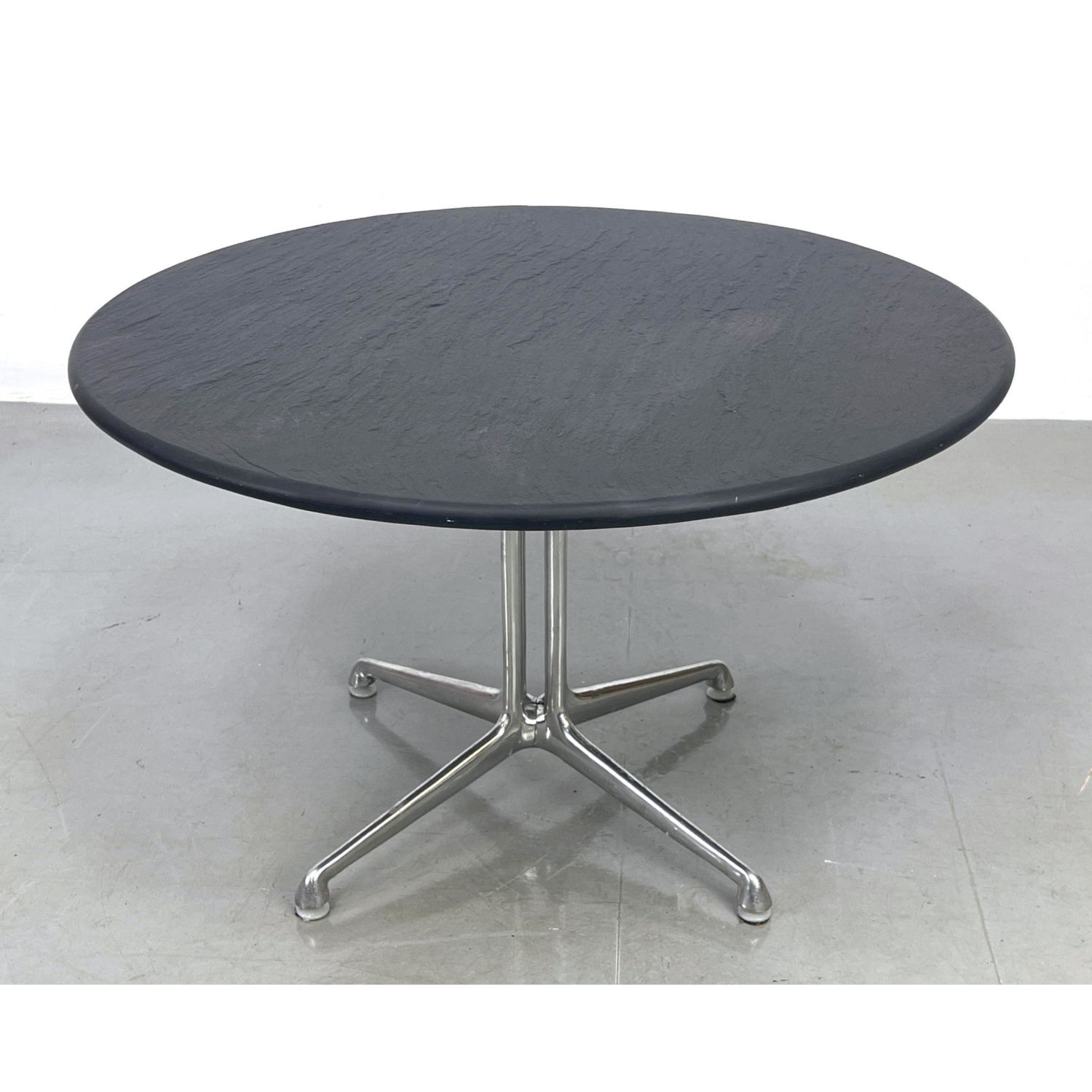 Appraisal: Eames La Fonda round slate top table Tagged Chrome base