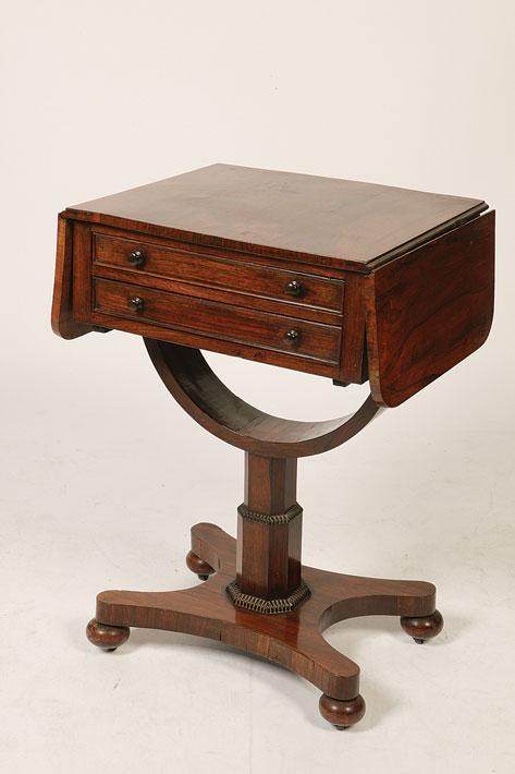 Appraisal: A REGENCY ROSEWOOD WORK TABLE the rectangular top with twin