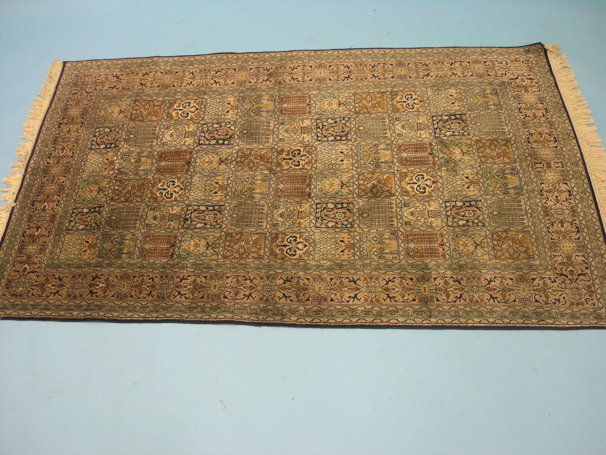 Appraisal: A silk rug floral designs predominantly in green cream and