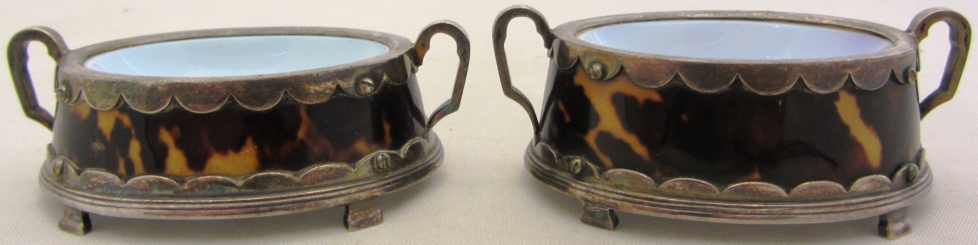 Appraisal: A pair of silver plated metal and tortoiseshell mounted salts