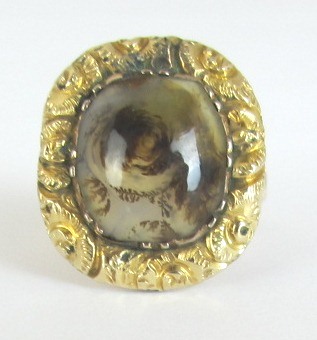 Appraisal: A gold ring mounted with a cushion shaped moss agate