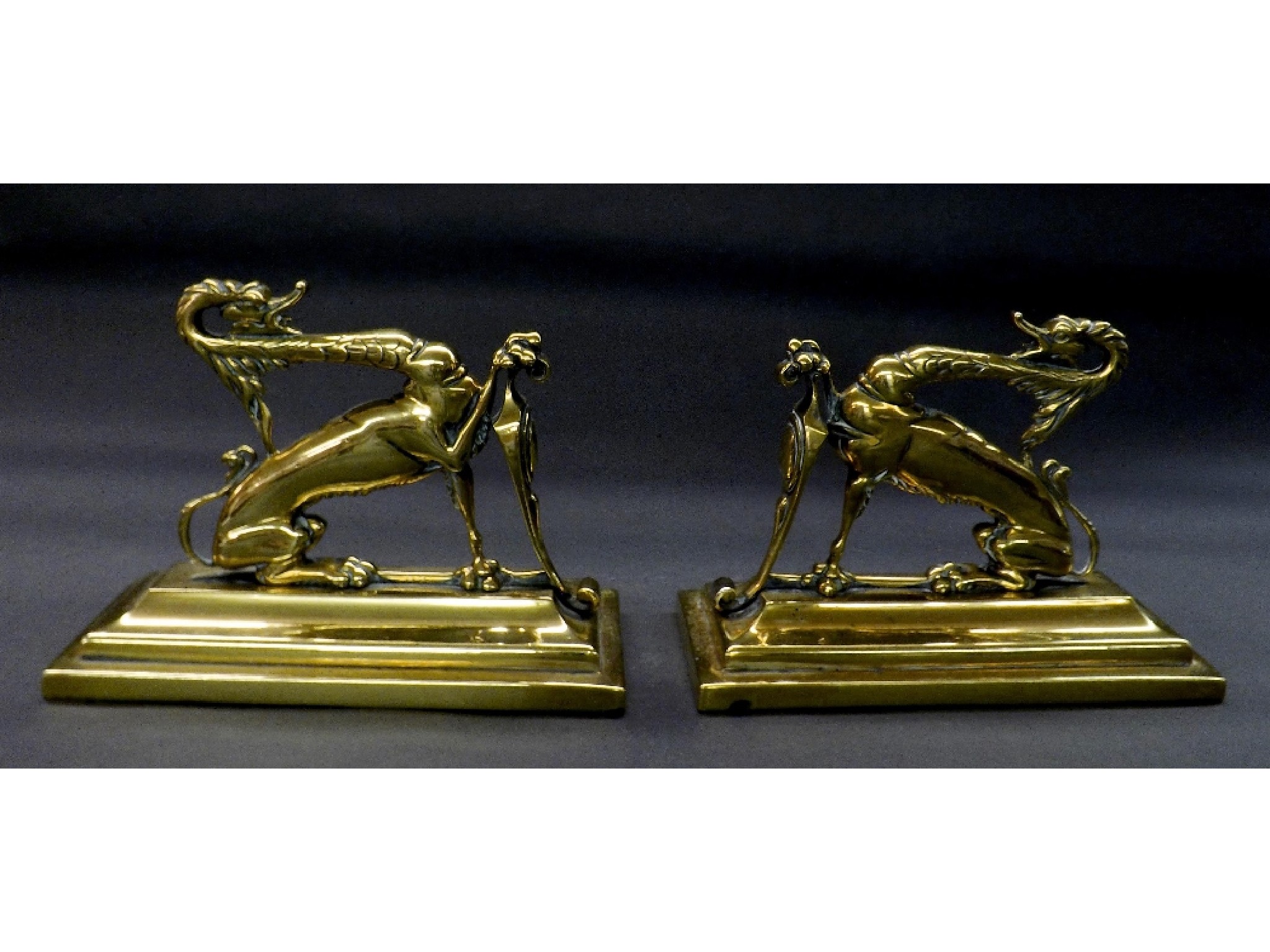 Appraisal: Pair of antique polished brass fire dogs in the form