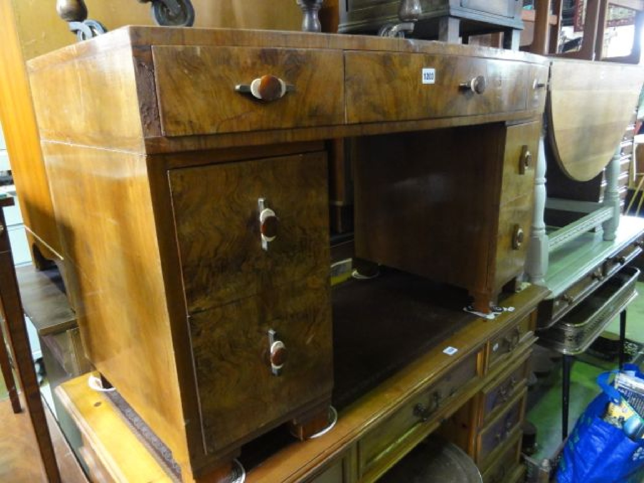 Appraisal: An Art Deco bow fronted walnut veneered kneehole twin pedestal