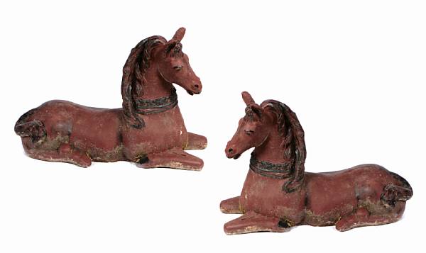 Appraisal: A pair of paint decorated stone models of recumbant horses