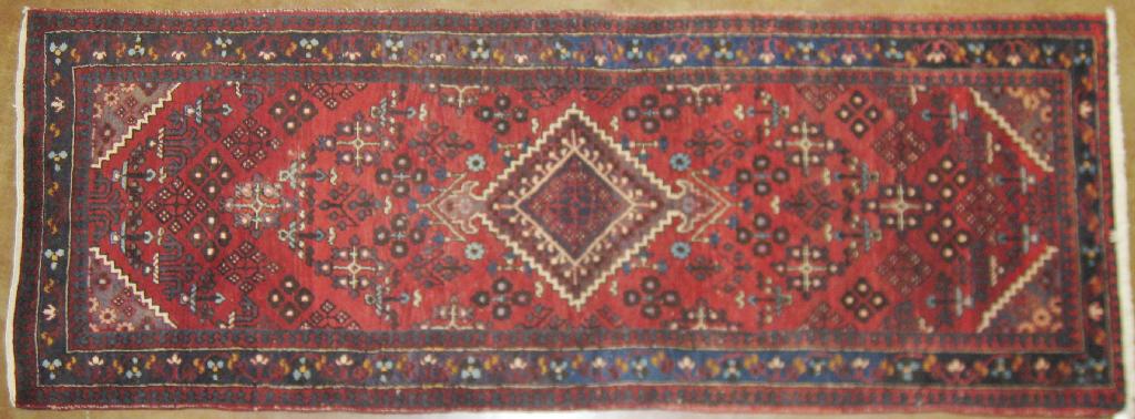 Appraisal: A bordered Oriental Runner with central lozenge blue on red