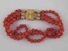 Appraisal: A three strand coral beaded bracelet with yellow metal tests