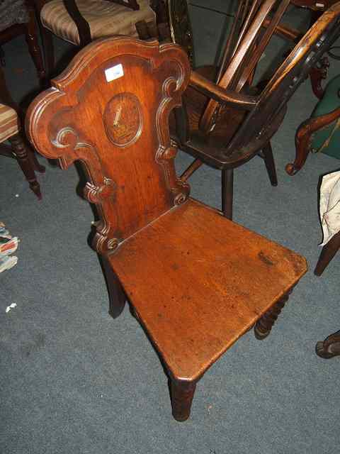 Appraisal: A TH CENTURY OAK HALL CHAIR the shaped back with