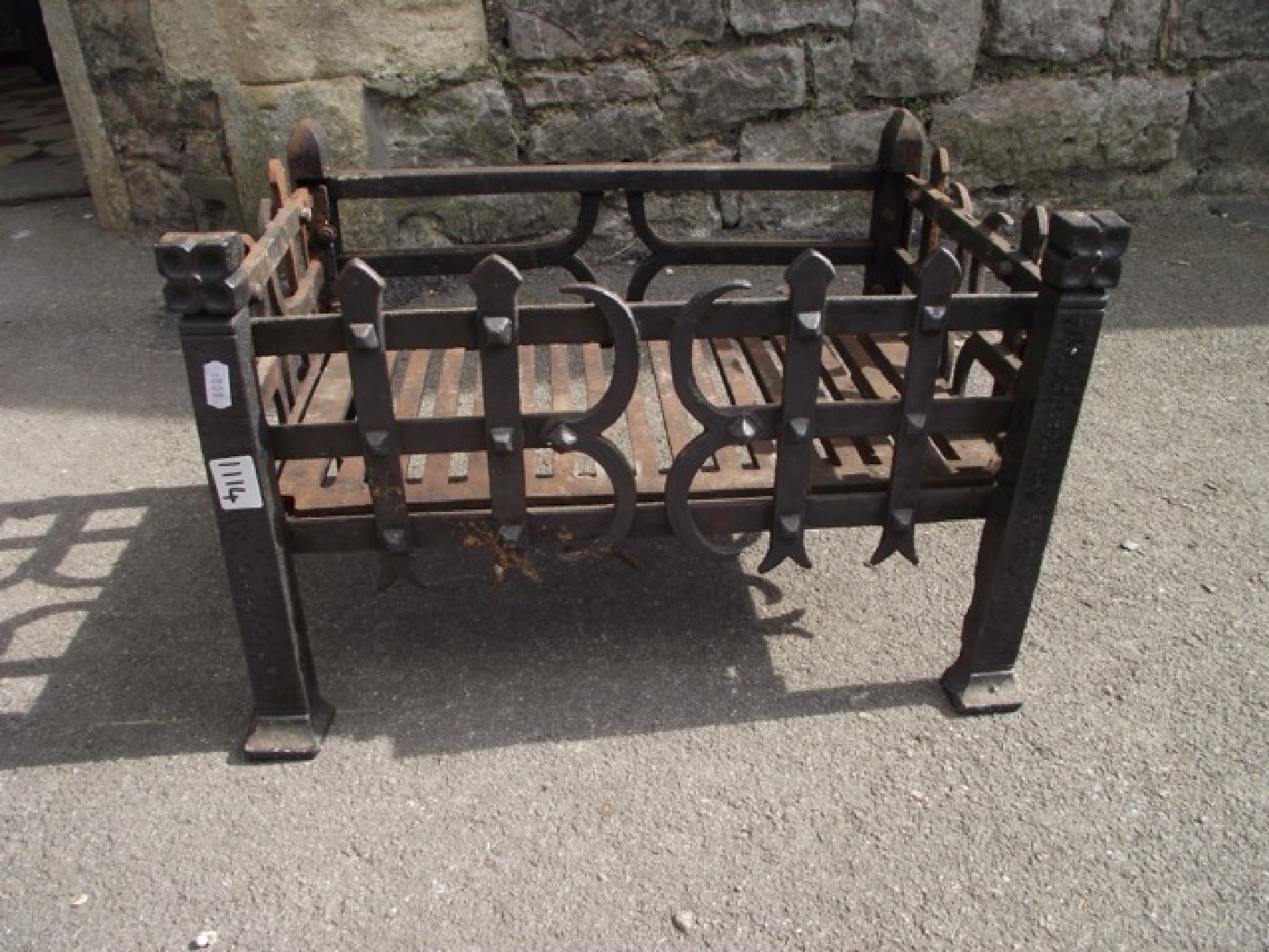 Appraisal: A small old English style cast iron fire basket with