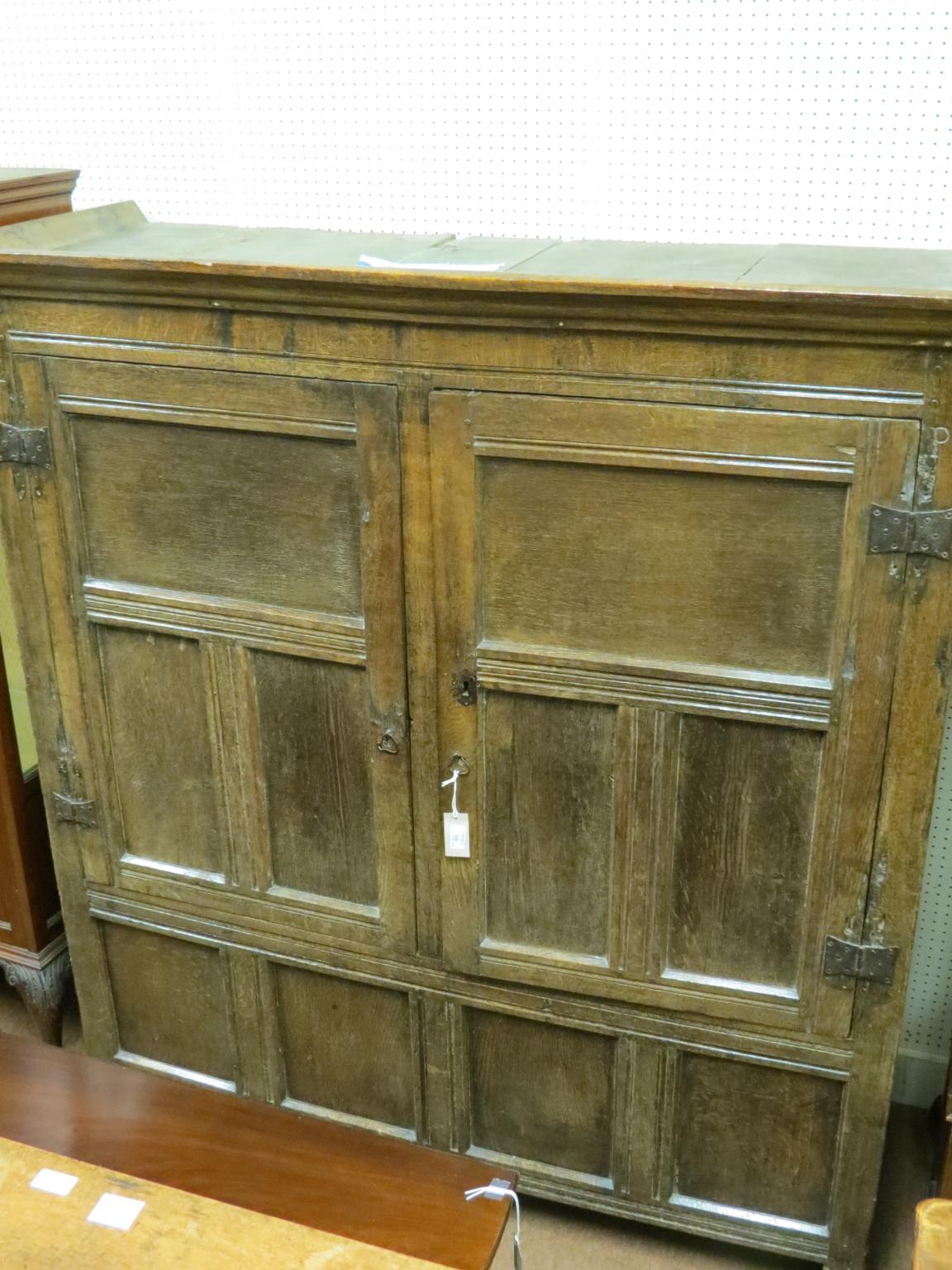 Appraisal: A late th early th century oak cupboard panelled construction