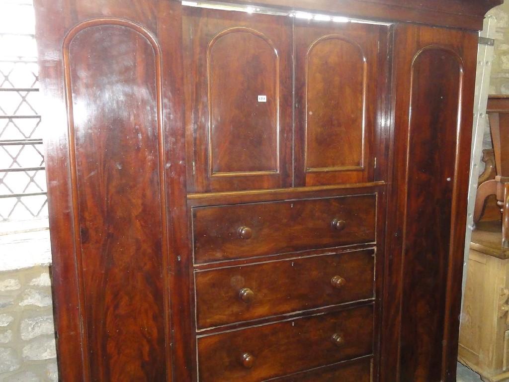 Appraisal: A Victorian mahogany inverted breakfront wardrobe the central section fitted