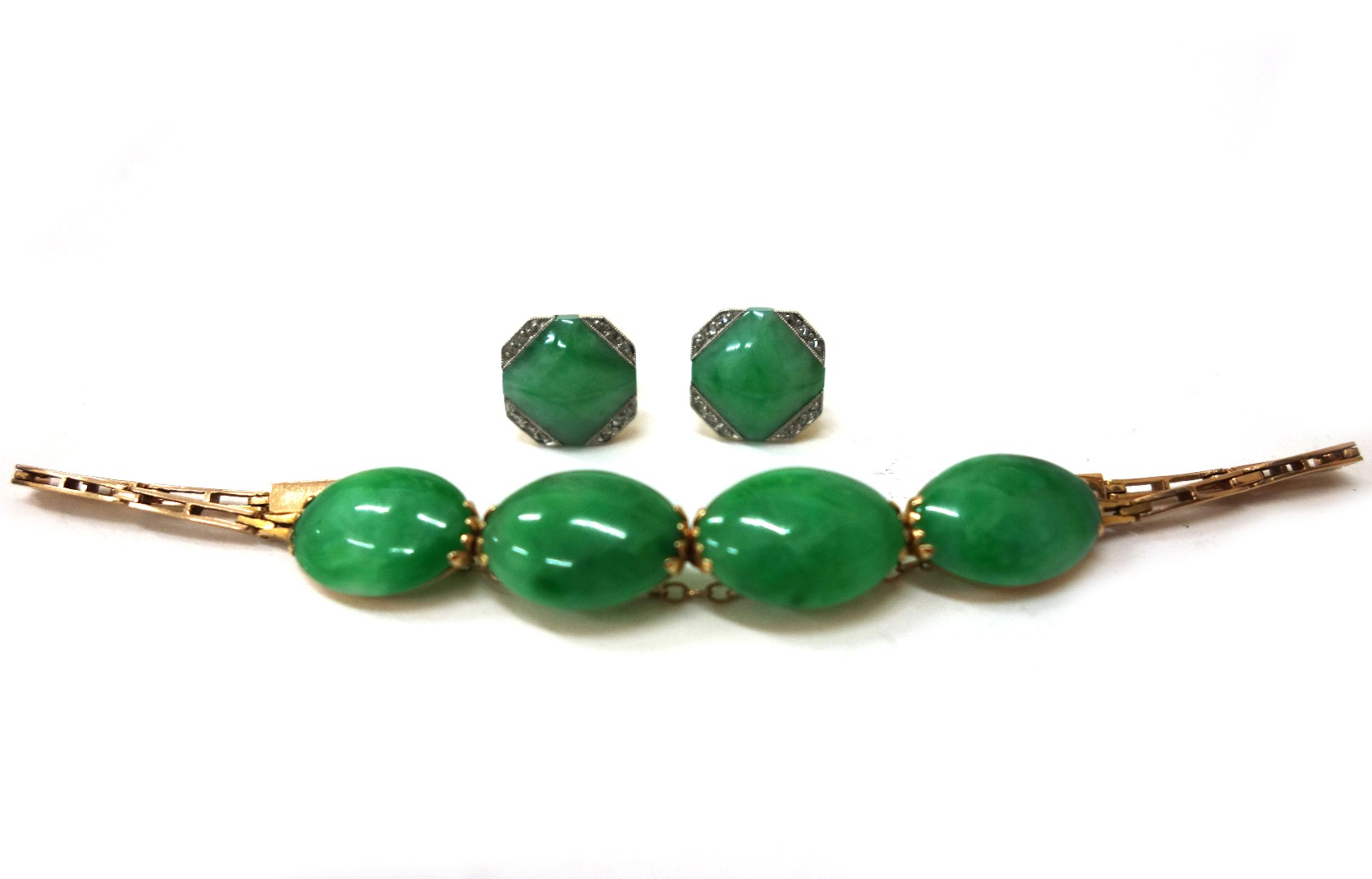 Appraisal: An early th century gold and jadeite four stone bracelet