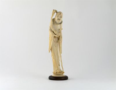 Appraisal: A Chinese ivory carving of a sage holding a gnarled