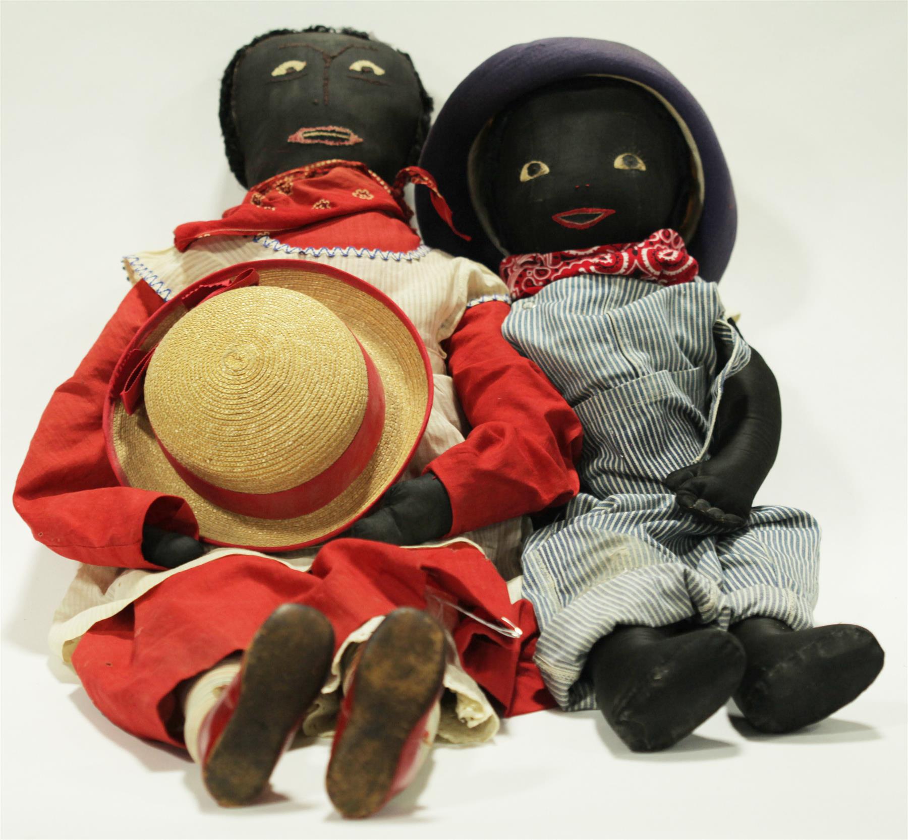 Appraisal: TWO BLACK CLOTH DOLLS WITH STITCHED FEATURES American Late th-early