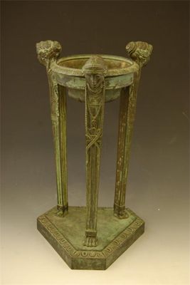 Appraisal: A bronze anthenienne with caryatid supports and a triform base