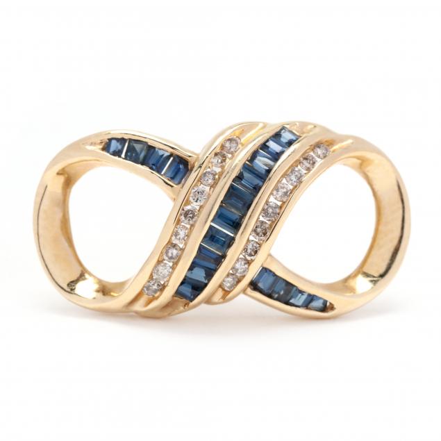 Appraisal: GOLD SAPPHIRE AND DIAMOND SLIDE In an elongated figure eight