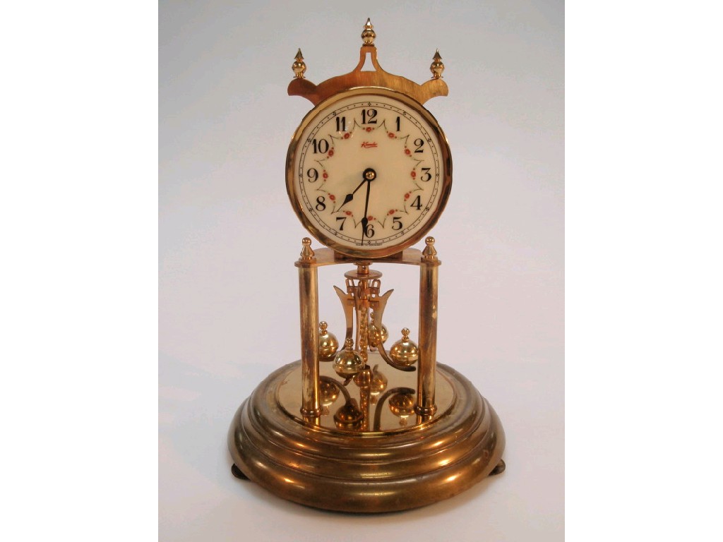 Appraisal: A Kundo perpetual movement mantel clock with an Arabic dial