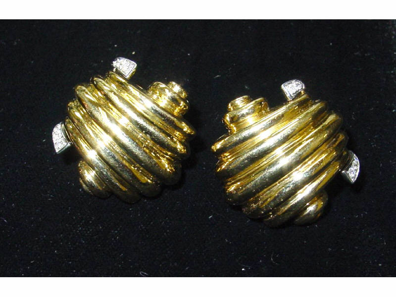 Appraisal: GOLD AND DIAMOND EARRINGS k yellow gold ribbed shell design