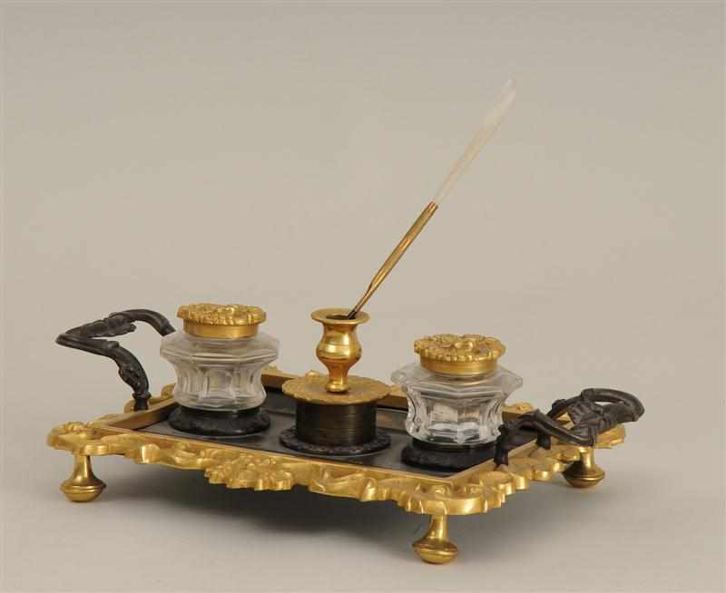 Appraisal: WILLIAM IV BRONZE AND GILT-METAL TWO-HANDLED INKSTAND With mask head