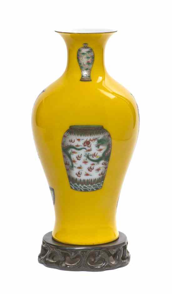 Appraisal: A Chinese Yellow Glazed Baluster Vase with a carved stand