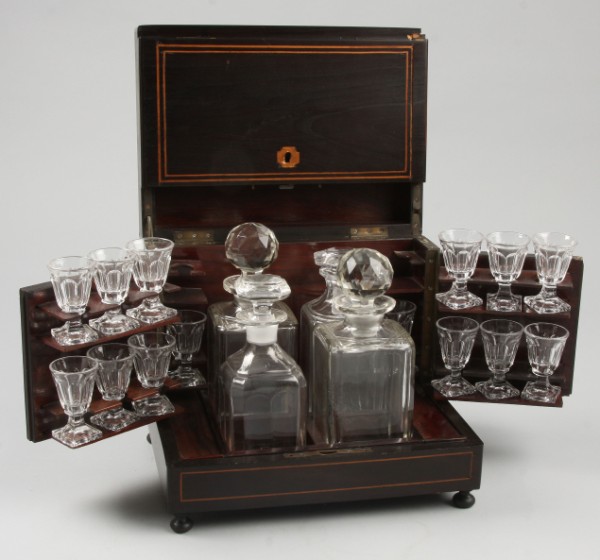 Appraisal: Tantalus set with inlaid decoration ball feet glasses and decaturs