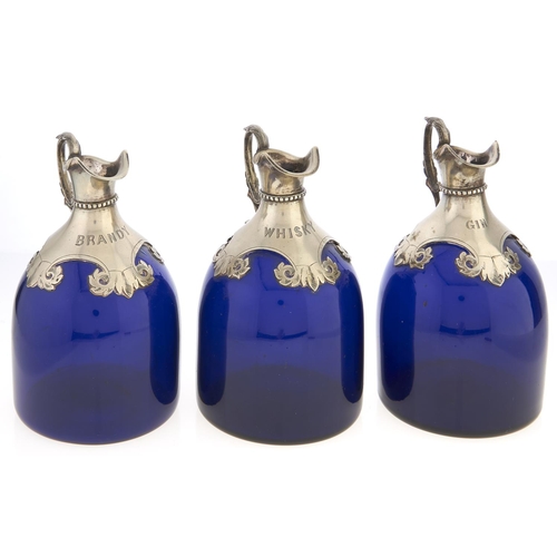 Appraisal: A set of three Victorian blue glass spirit flasks engraved