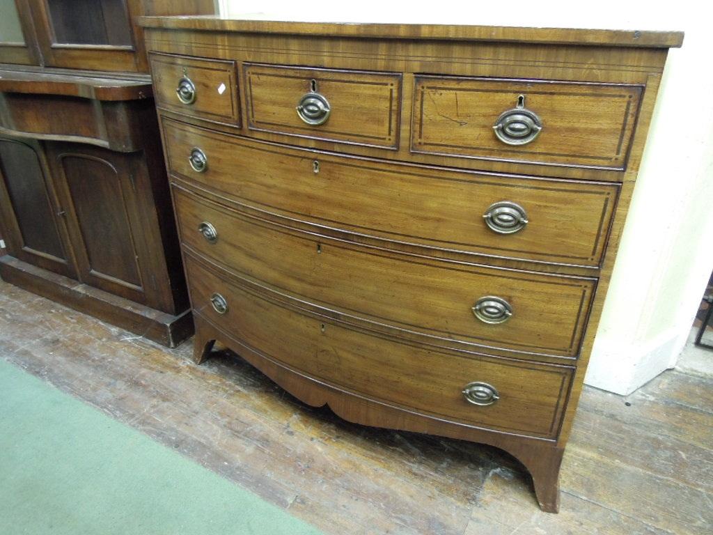 Appraisal: A Georgian mahogany bow fronted chest fitted with an arrangement