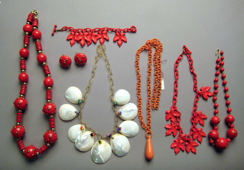 Appraisal: Three red bakelite celluloid wood and brass necklaces two with