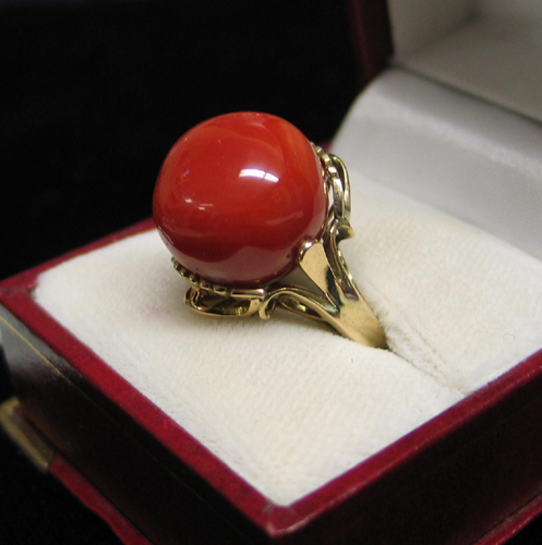 Appraisal: RED CORAL AND FOURTEEN KARAT GOLD RING set with a